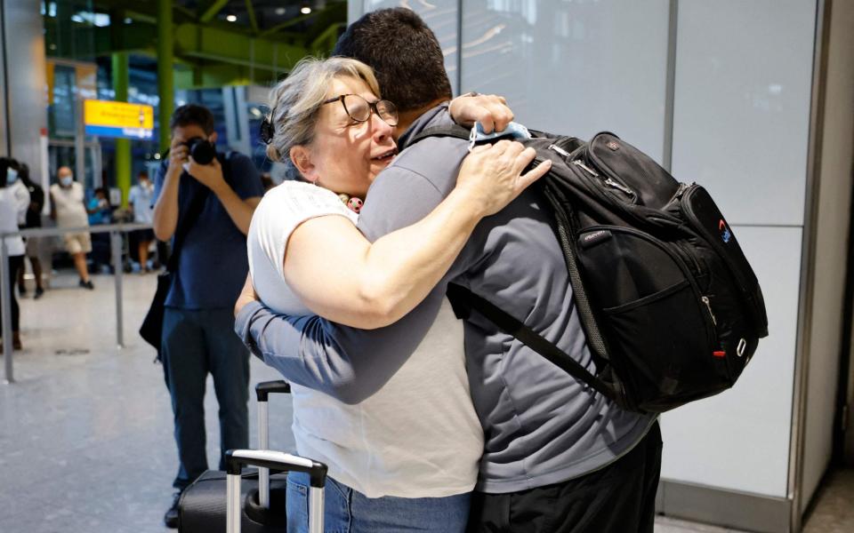 Relatives were reunited at Heathrow on Monday morning as restrictions around quarantine-free travel changed - Tolga Akmen/AFP