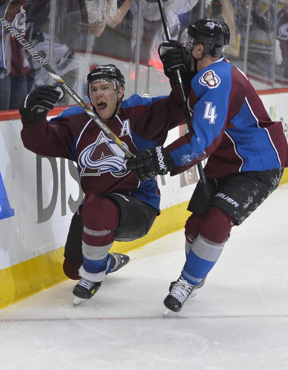 Colorado Avalanche center Paul Stastny (26) celebrates his game winning goal against the Minnesota Wild with Tyson Barrie (4) during the fourth period in Game 1 of an NHL hockey first-round playoff series on Thursday, April 17, 2014, in Denver. Colorado beat Minnesota 5-4 in overtime. (AP Photo/Jack Dempsey)