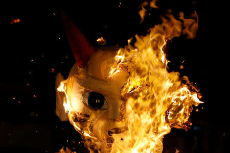 A pinata representing U.S. President-elect Donald Trump as a devil is seen burning during the traditional Burning of the Devil festival, ahead of Christmas in Guatemala City, Guatemala December 7, 2016. REUTERS/Luis Echeverria