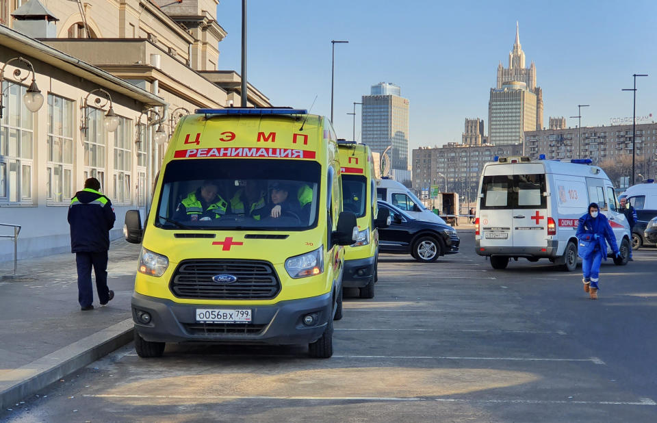 In this file photo taken on Friday, Feb. 21, 2020, Ambulance cars are parked while medics check passengers where a passenger was identified with suspected coronavirus after arriving from Kyiv at Kievsky (Kyiv's) rail station in Moscow, Russia. Russia suspended all trains to China and North Korea, shut down its land border with China and Mongolia and extended a school vacation for Chinese students until March 1. Russian authorities are going to great lengths to prevent the new coronavirus from spreading in the capital and elsewhere. (Denis Voronin, Moscow News Agency photo via AP, File)