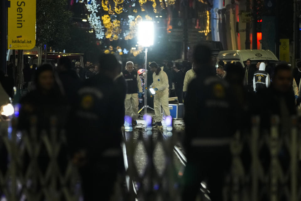 Security forensic officials work at the area after an explosion on Istanbul's popular pedestrian Istiklal Avenue, Sunday, Nov. 13, 2022. (AP Photo/Francisco Seco)
