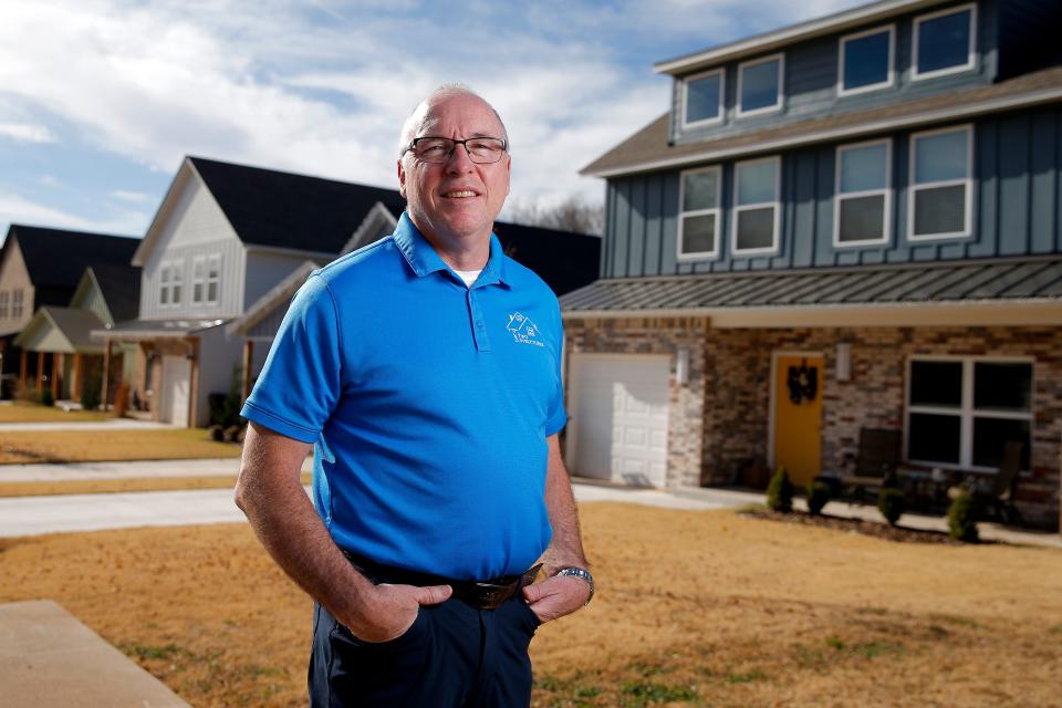 Jay Evans, owner of Two Structures Homes, stands in front of a row of his company's houses on Main Street in Arcadia.