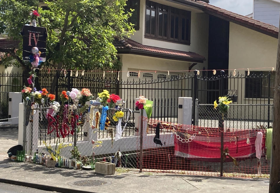 FILE - In this April 28, 2021, file photo, floral bouquets, deflated balloons, candles and other items decorate a street memorial by the Kalakaua Canal where Honolulu Police shot and killed 16-year-old Iremamber Sykap, whose nickname was Baby, during a car chase on Kalakaua Ave., in Honolulu. The teenager arrived at an emergency room with gunshot wounds to the back of his head and to his shoulders, according to hospital records provided by a lawyer representing the teen's family. (AP Photo/Jennifer Sinco Kelleher, File)