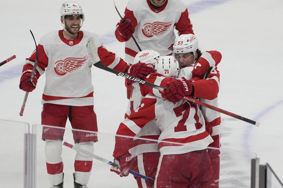 Detroit Red Wings center Dylan Larkin (71) is congratulated by his teammates after scoring the game winning goal in overtime at an NHL hockey game against the Florida Panthers, Wednesday, Jan. 17, 2024, in Sunrise, Fla. The Red Wings defeated the Panthers 3-2. (AP Photo/Marta Lavandier)