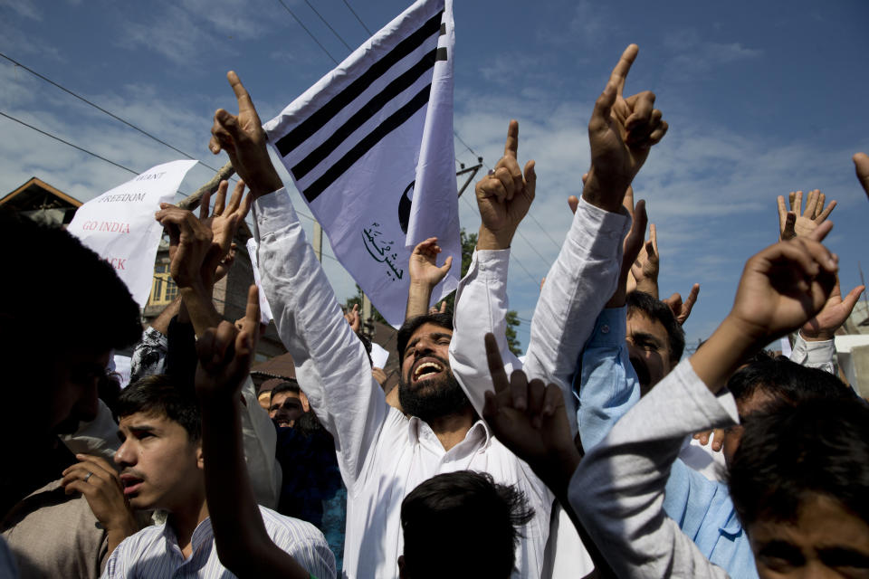 Kashmiri Muslims shout slogans during a protest after Eid prayers in Srinagar, Indian controlled Kashmir, Monday, Aug. 12, 2019. Troops in India-administered Kashmir allowed some Muslims to walk to local mosques alone or in pairs to pray for the Eid al-Adha festival on Monday during an unprecedented security lockdown that still forced most people in the disputed region to stay indoors on the Islamic holy day. (AP Photo/ Dar Yasin)