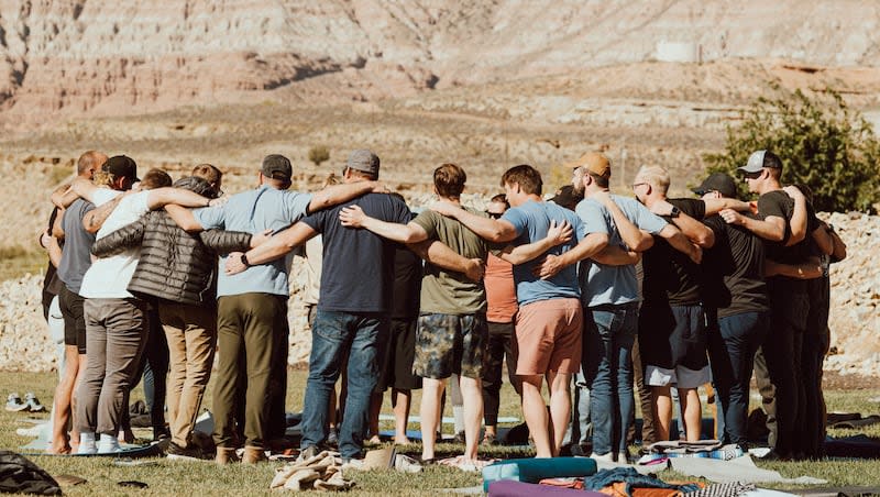 A group of men with Heare Brotherhood form a circle during their retreat last year at Zion Wildflower Resort near Zion’s National Park in 2023. Heare Brotherhood, a nonprofit based in Utah, is on a mission to cure loneliness.