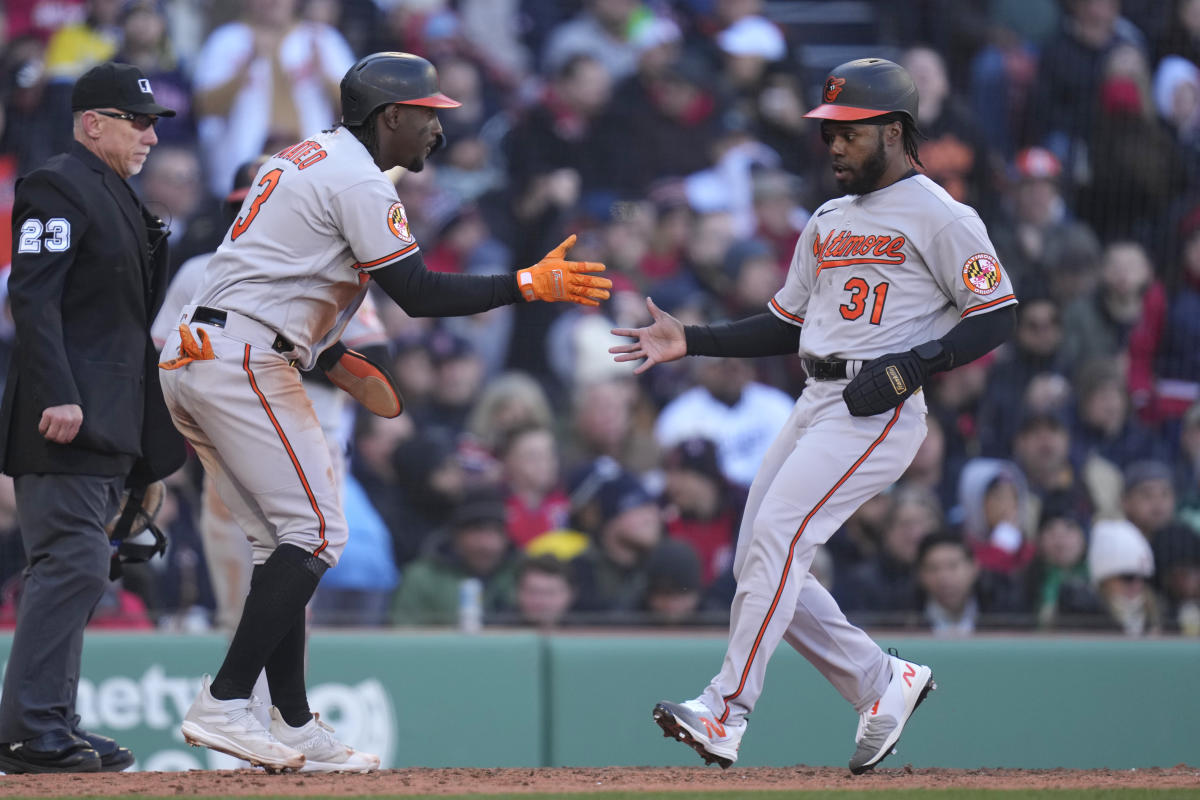 The clock atop the scoreboard at Oriole Park at Camden Yards is visible in  the first inning of a baseball game between the Baltimore Orioles and the  Boston Red Sox, Wednesday, April