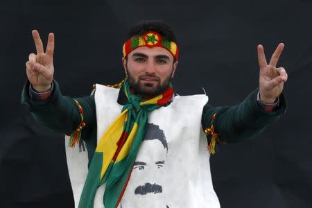 A Kurdish man poses for a picture as he arrives for a gathering celebrating Newroz in Diyarbakir March 21, 2015. REUTERS/Umit Bektas