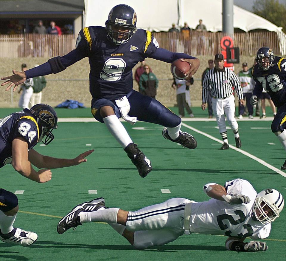Kent State quarterback Joshua Cribbs leaps over the tackle attempt of Ohio's Rob Stover in the second quarter at Dix Stadium, Saturday, Oct. 19, 2002.