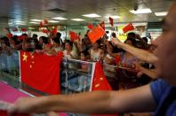 Pro-China demonstrators wave Chinese national flags at Amoy Plaza shopping mall in Kowloon Bay, Hong Kong