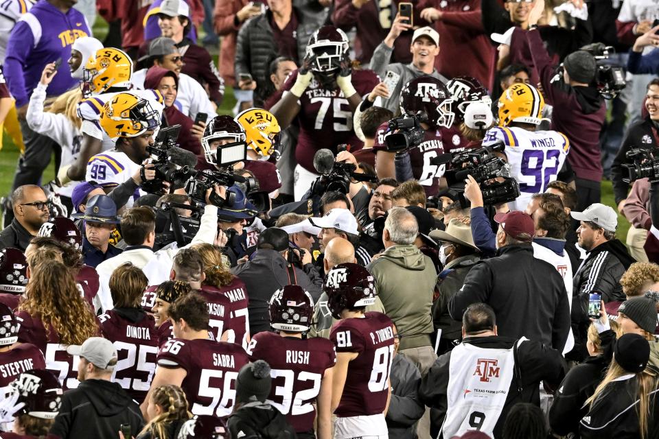 Texas A&M head coach Jimbo Fisher, center, and LSU's Brian Kelly meet among the crowd at Kyle Field moments after the Aggies' 38-23 win over LSU in last year's regular-season finale. Six years into a lucrative contract, Fisher continues to struggle to find his footing in the SEC.
