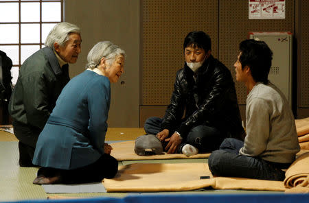 FILE PHOTO : Japan's Emperor Akihito (L) and Empress Michiko (2nd L) talk with evacuees from the March 11 earthquake and tsunami, at Tokyo Budoh-kan, currently an evacuation shelter, in Tokyo March 30, 2011. REUTERS/Issei Kato/File Photo