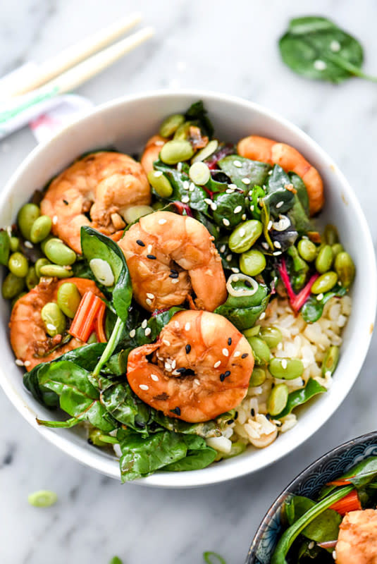 <p>Foodie Crush</p><p>This sesame shrimp stir fry with Swiss chard, edamame and spinach, and served over brown rice for a quick, easy and healthy recipe for a weeknight dinner!</p><p><strong>Get the recipe: <a href="https://www.foodiecrush.com/sesame-shrimp-asian-greens-rice-bowl/" rel="nofollow noopener" target="_blank" data-ylk="slk:Sesame Shrimp and Asian Greens Rice Bowl;elm:context_link;itc:0;sec:content-canvas" class="link ">Sesame Shrimp and Asian Greens Rice Bowl</a></strong></p>