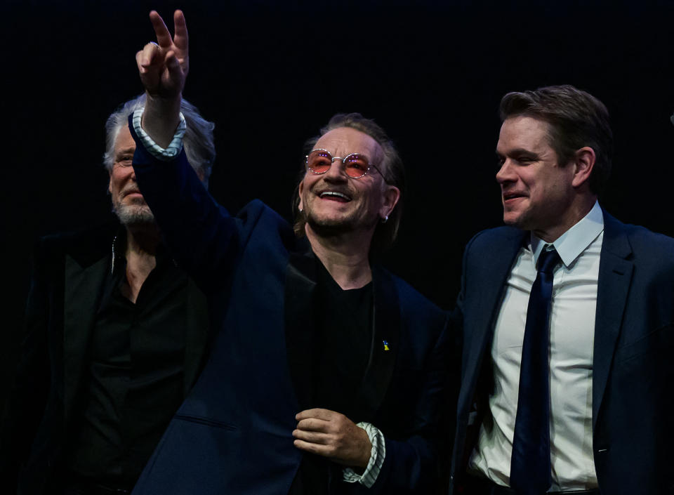 L-R U2's Adam Clayton, Bono, and producer Matt Damon greet the public after a screening of the film 'Kiss the Future' presented in the Berlinale Special section at the Berlinale, Europe's first major film festival of the year, in Berlin on February 19, 2023. 