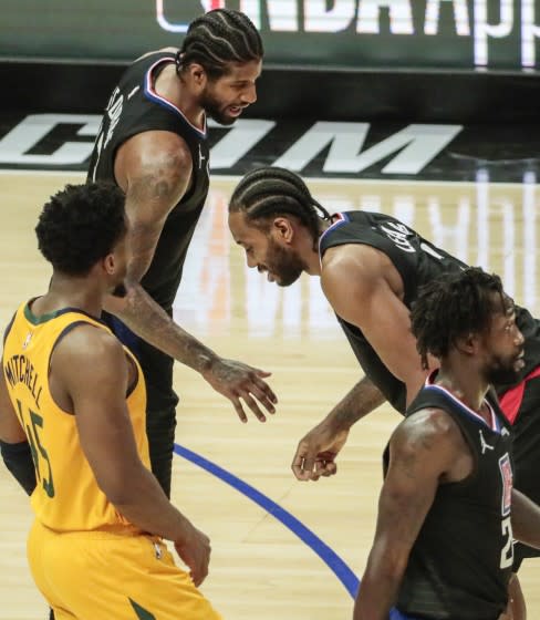 Clippers forward Kawhi Leonard is in pain as teammate Paul George checks on him during Game 4 against the Jazz.