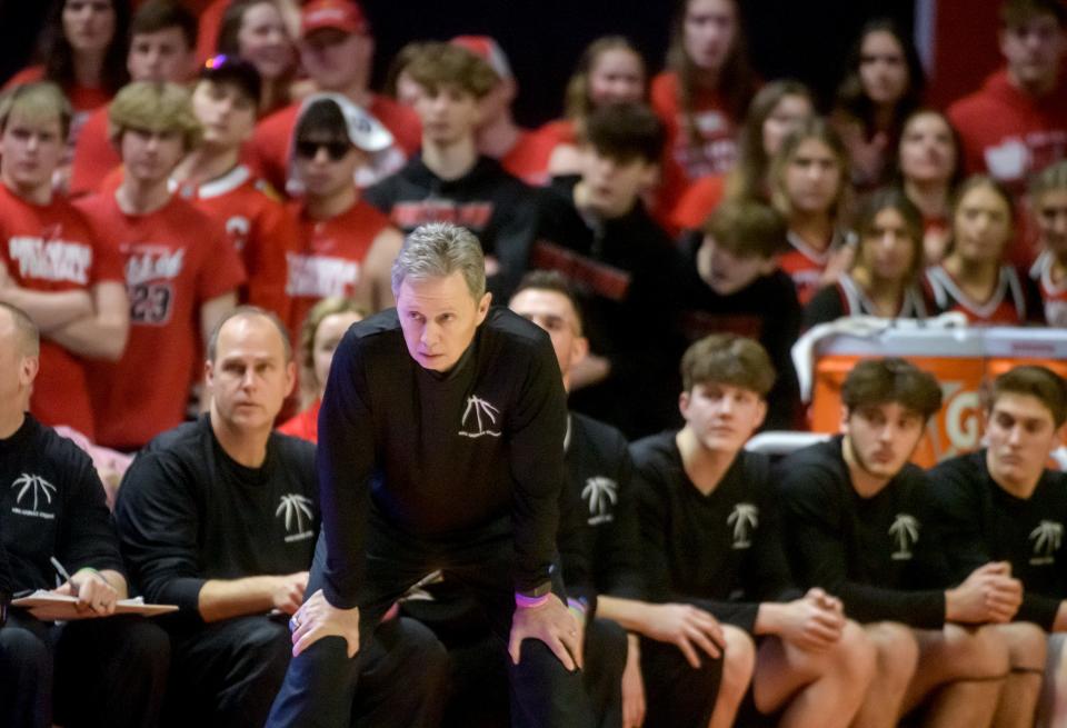 Metamora head coach Danny Grieves, the bench, and fans watch with some concern as the Redbirds fall behind Chicago Simeon in the first half of the Class 3A basketball state title game Saturday, March 11, 2023 at State Farm Center in Champaign. The Redbirds rallied to take the title 46-42.