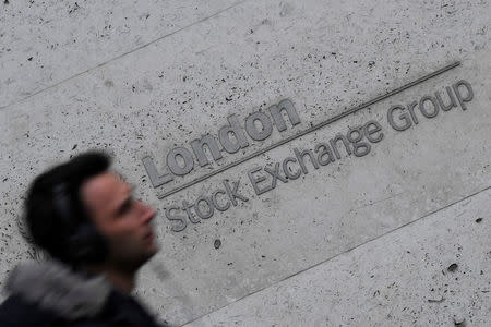 People walk past the London Stock Exchange Group offices in the City of London, Britain, December 29, 2017. REUTERS/Toby Melville