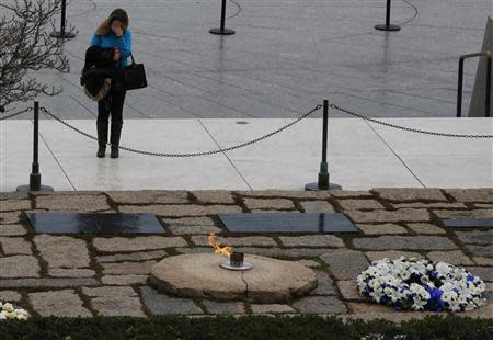 REFILE - CORRECTING TAGS A woman pays her respects at Arlington National Cemetery to mark the 50th anniversary of the assassination of U.S. President John F. Kennedy at his gravesite in Arlington, November 22, 2013. REUTERS/Larry Downing