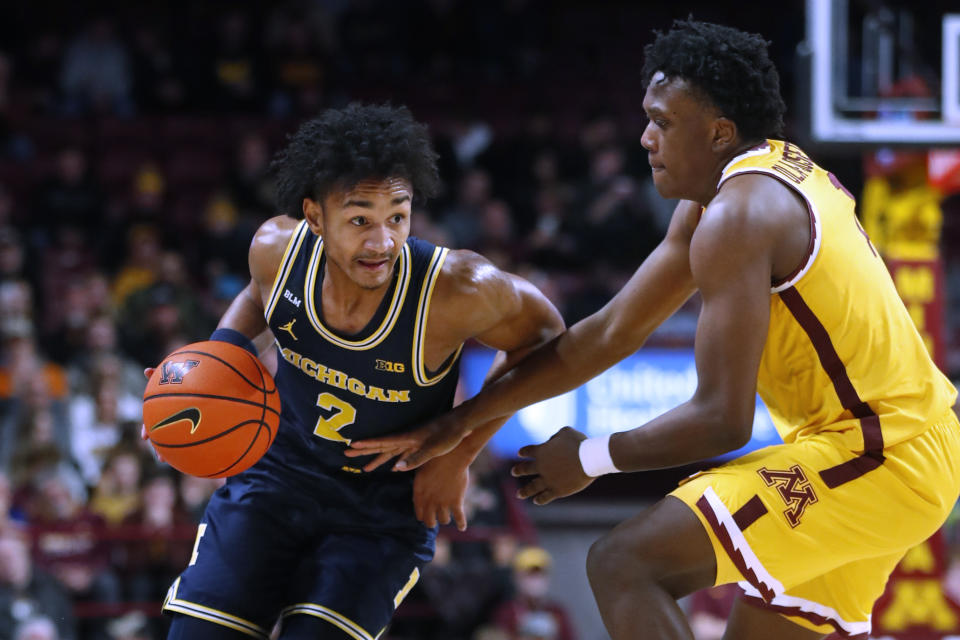 Michigan guard Kobe Bufkin (2) drives around Minnesota forward Joshua Ola-Josep during the second half of an NCAA college basketball game Thursday, Dec. 8, 2022, in Minneapolis. (AP Photo/Bruce Kluckhohn)