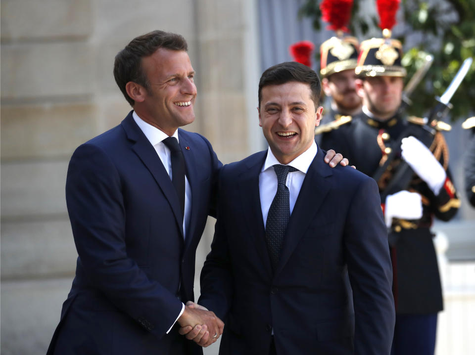 FILE - French President Emmanuel Macron, right, greets Ukrainian President Volodymyr Zelenskyy before their meeting at the Elysee Palace, in Paris, Monday, June 17, 2019. Rarely in recent years has the Kremlin been so popular with European visitors. French President Emmanuel Macron arrives Monday, Feb. 7, 2022. The Hungarian prime minister visited last week. And in days to come, the German chancellor will be there, too. Macron will travel to Kyiv on Tuesday. (AP Photo/Christophe Ena, File)