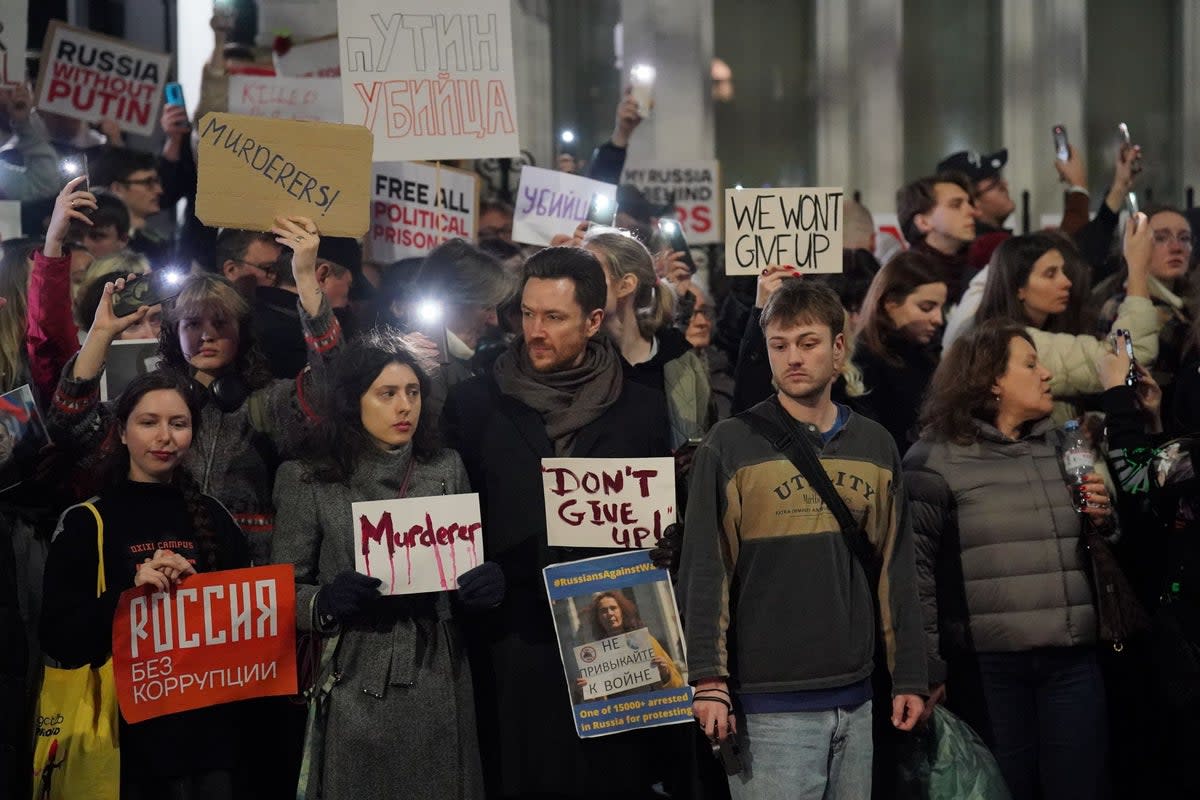 People take part in a protest opposite the Russian Embassy in London, organised by Voice for Global Democracy, on Friday night (Jonathan Brady/PA Wire)