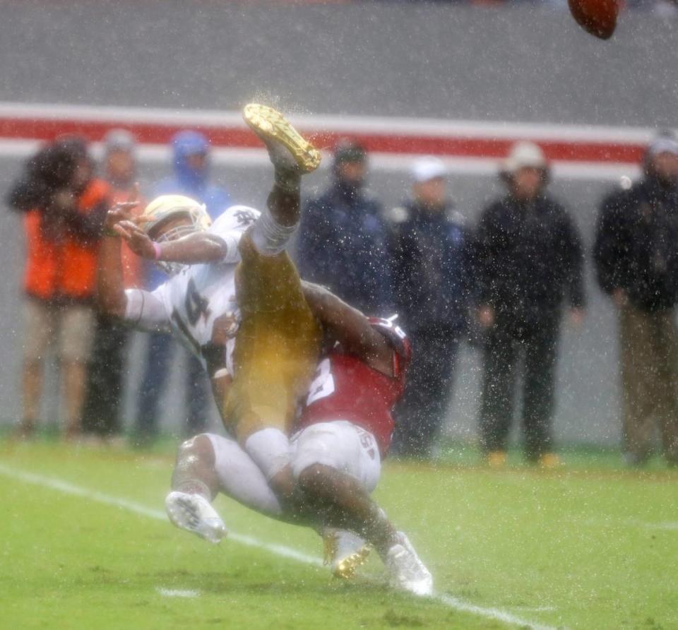 N.C. State linebacker Airius Moore (58) tackles Notre Dame quarterback DeShone Kizer (14) as Kizer releases the ball during the second half of N.C. State’s 10-3 victory over Notre Dame at Carter-Finley Stadium in Raleigh, N.C., Saturday, Oct. 8, 2016.