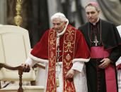 FILE - This Feb. 9, 2013 file photo shows Pope Benedict XVI flanked by personal secretary Archbishop Georg Gaenswein during a Mass to mark the 900th anniversary of the Order of the Knights of Malta in St. Peter's Basilica at the Vatican. Archbishop Georg Gaenswein told a book presentation Tuesday, Sept. 11, 2018, that the sex abuse scandal that has convulsed the Catholic Church for years is "its own 9/11." (AP Photo/Gregorio Borgia, files)