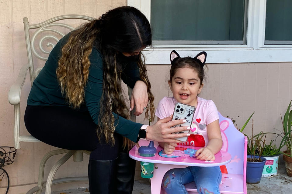 Image: Safieh Mohammadi, who lives in Houston, and her daughter, Lili, video chat Bahram, who is currently in Canada. (Randy Foster / NBC News)