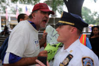 <p>A Trump supporter yells at a police officer as other protesters march against President Trump’s proposed end of the DACA program that protects immigrant children from deportation in New York City, Aug. 30, 2017. (Photo: Joe Penney/Reuters) </p>