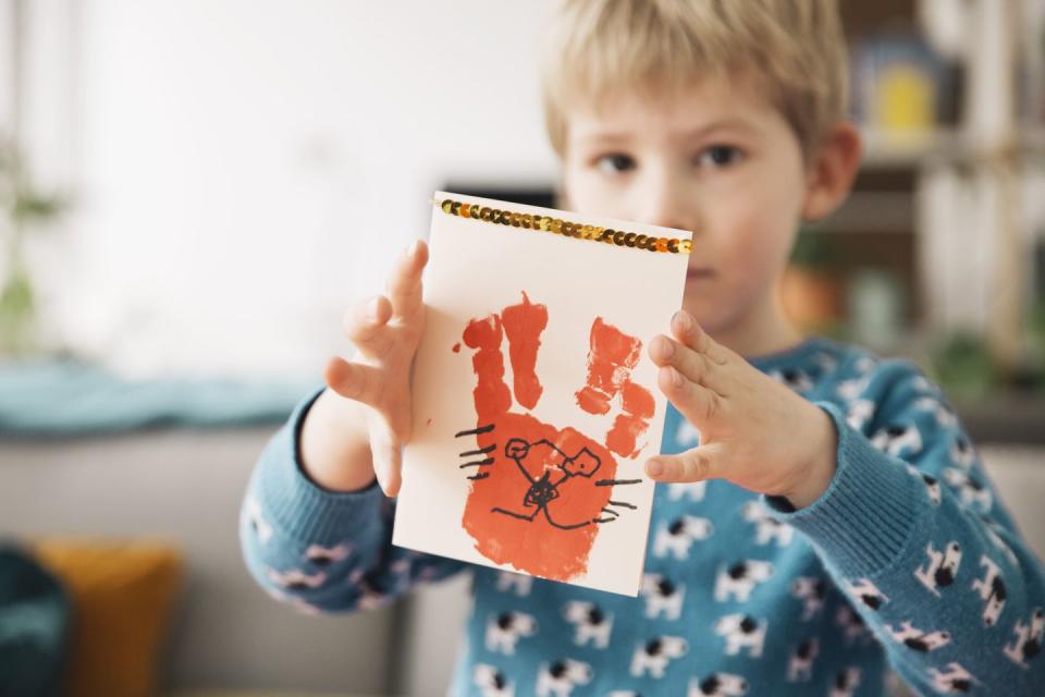 little boy presenting self made easter card