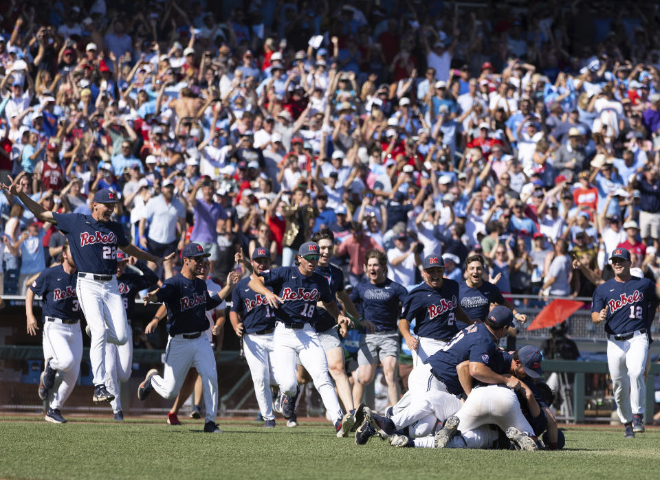 Mississippi players dogpile following their victory over Oklahoma to win Game 2 of the NCAA College World Series baseball finals, Sunday, June 26, 2022, in Omaha, Neb. (AP Photo/Rebecca S. Gratz)