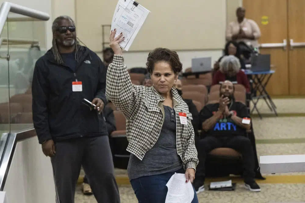 Dawn Basciano holds up legal documents while speaking during public comments at the California Reparations Task Force meeting, Wednesday, March 29, 2023, in Sacramento, Calif. (Hector Amezcua/The Sacramento Bee via AP, File)