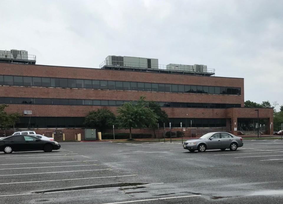 An expansive parking lot behind the Burlington County Human Services Facility in Westampton could house a future shelter for the homeless. There is other parking in front of and along one side of the building.