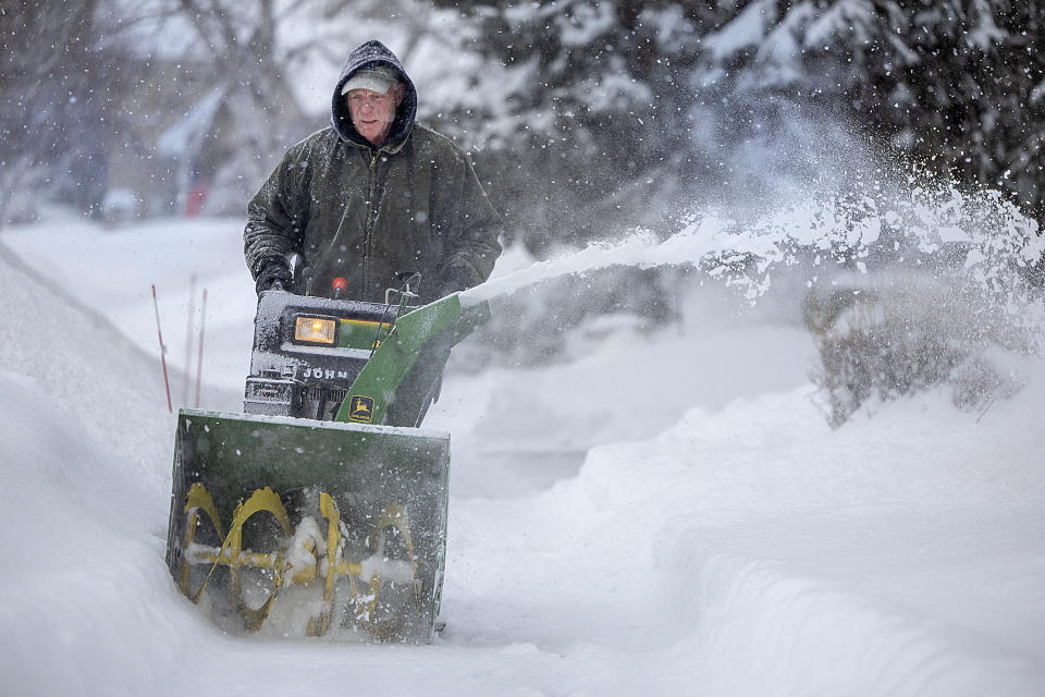 Dale Anderson makes his way snow blowing down his sidewalk in Burnsville, Minn., on Thursday, Feb. 23, 2023. Dangerous winter weather is ravaging the nation from California through the northern Plains. (Elizabeth Flores /Star Tribune via AP)