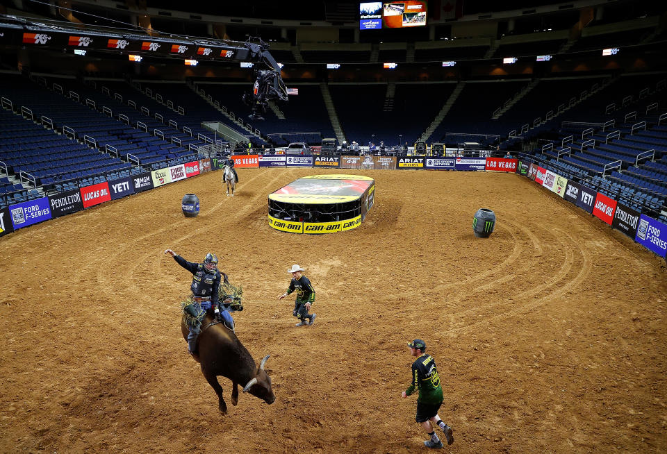 The bulls were bucking and the riders were riding, but the fans weren't there. (Photo by Kevin C. Cox/Getty Images)