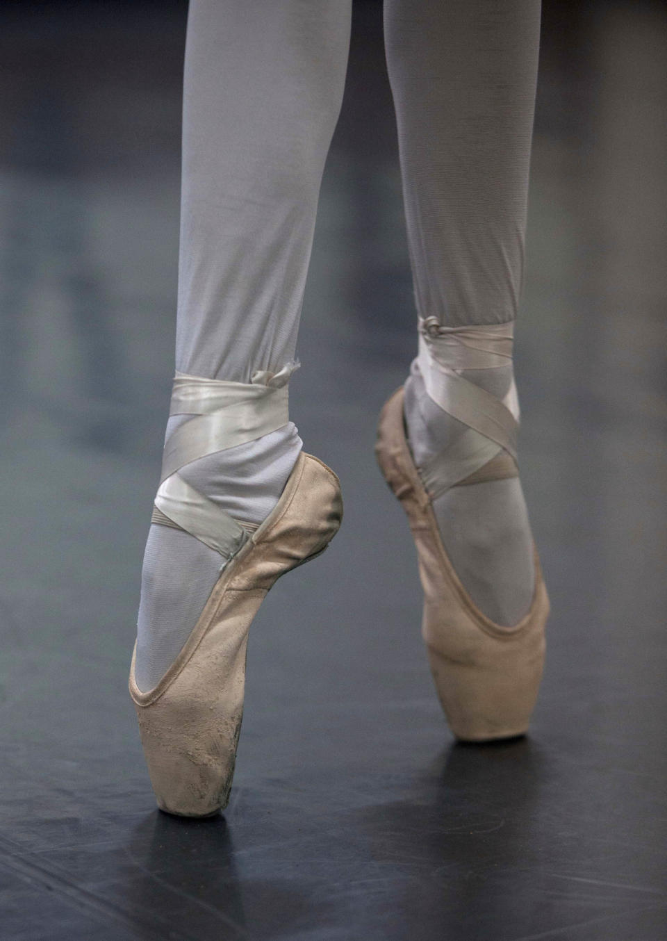 In this Aug. 28, 2012 photo, a dancer stands on her toes as she trains for a ballet competition at the National Superior Ballet School in Lima, Peru. Nearly 100 girls and boys from Colombia, Venezuela, Chile, France and Peru are submitting themselves to a week-long competition hoping to win medals from Peru's national ballet school _ and perhaps a grant to study in Miami. (AP Photo/Martin Mejia)