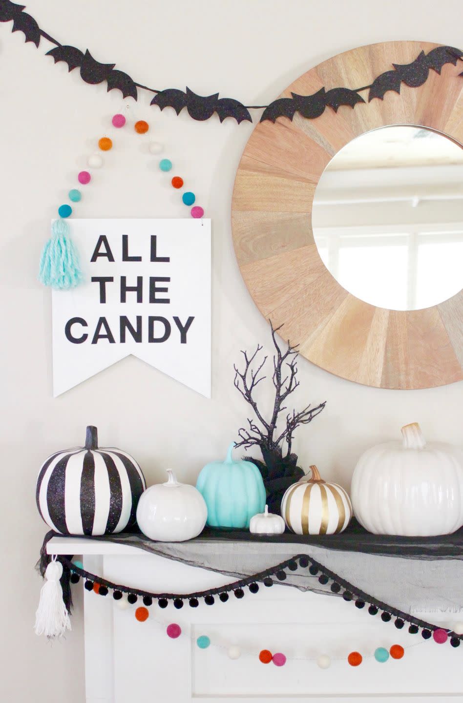 <p>This blogger paired warm wood with bold black-and-white pieces and small pops of color for a more sophisticated and happy Halloween mantel display.</p><p><strong>See more at <a href="http://www.rebeccapropes.com/2016/10/halloween-mantel-decor/" rel="nofollow noopener" target="_blank" data-ylk="slk:Make and Do Studios;elm:context_link;itc:0;sec:content-canvas" class="link ">Make and Do Studios</a>.</strong> </p>