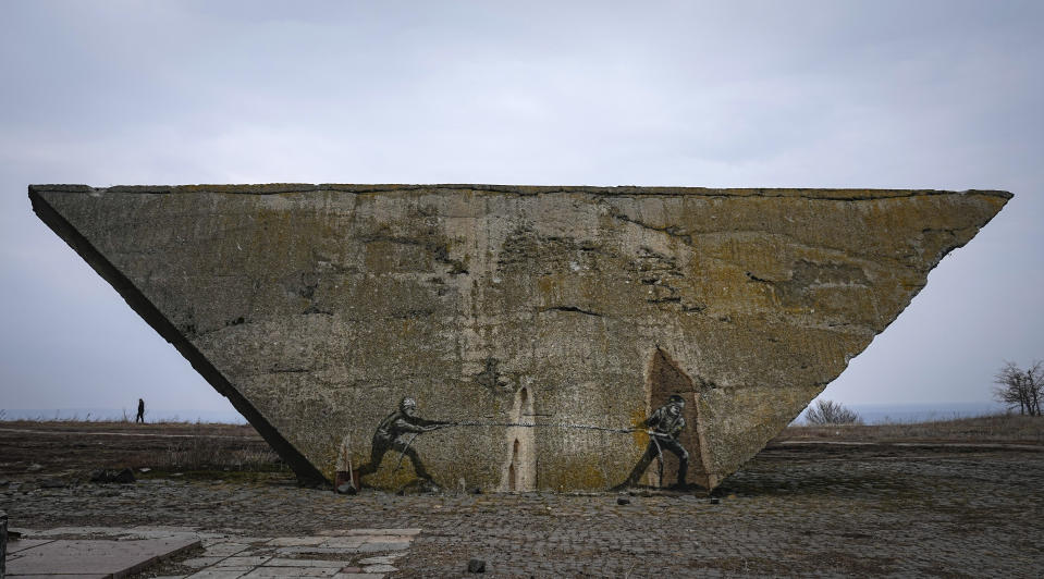 Ukrainian and Russian soldiers are depicted in a tug-of-war game on a memorial in Izium, Kharkiv region, Ukraine, Sunday, March 17, 2024. (AP Photo/Efrem Lukatsky)