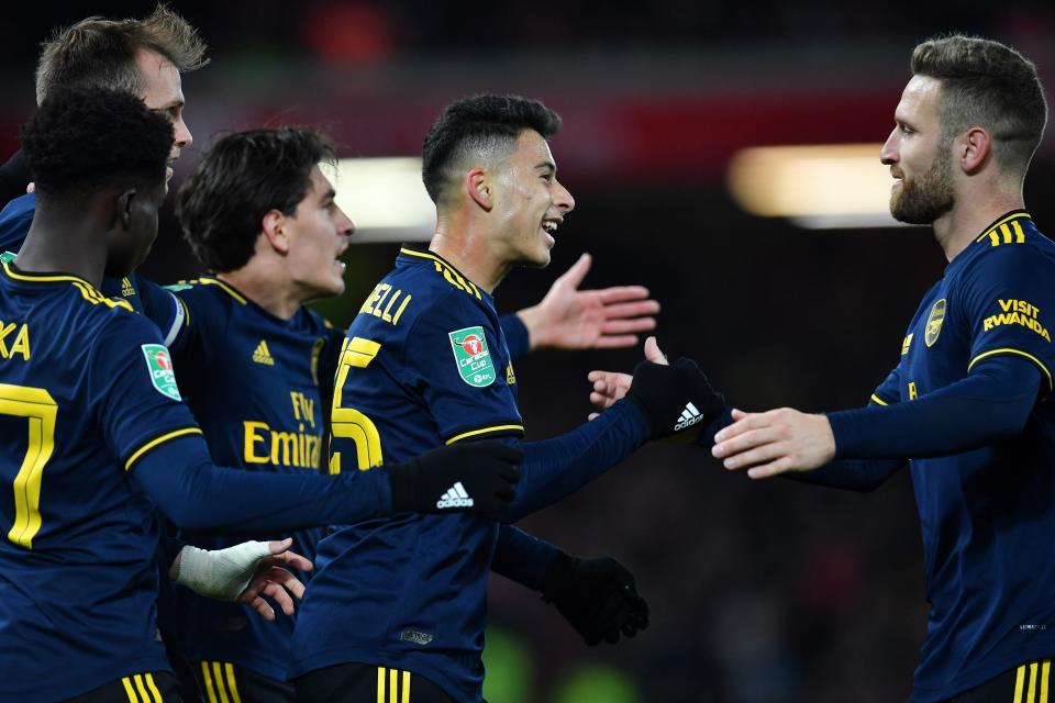 Arsenal's Brazilian striker Gabriel Martinelli (C) scores his team's second goal with Arsenal's German defender Shkodran Mustafi (R) during the English League Cup fourth round football match between Liverpool and Arsenal at Anfield in Liverpool, north west England on October 30, 2019. (Photo by Paul ELLIS / AFP) / RESTRICTED TO EDITORIAL USE. No use with unauthorized audio, video, data, fixture lists, club/league logos or 'live' services. Online in-match use limited to 75 images, no video emulation. No use in betting, games or single club/league/player publications. /  (Photo by PAUL ELLIS/AFP via Getty Images)