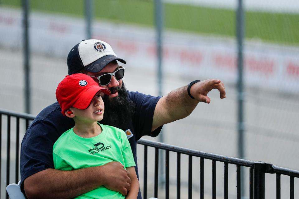 Tony Gibson Jr. watches  IMSA WeatherTech SportsCar practice with his son Tony Gibson III during the Detroit Grand Prix's Free Prix Day in Detroit on Friday, June 3, 2022.