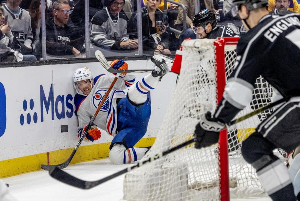 Edmonton Oilers forward Derek Ryan hits the boards in front of Kings forward Kevin Fiala.