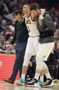 Cleveland Cavaliers' Dante Exum, center, is helped off the court after an injury in the first half of an NBA basketball game against the Miami Heat, Monday, Feb. 24, 2020, in Cleveland. (AP Photo/Tony Dejak)