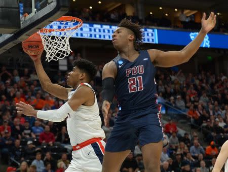 Mar 21, 2019; Salt Lake City, UT, USA; Gonzaga Bulldogs forward Rui Hachimura (left) scores past Fairleigh Dickinson Knights forward Elyjah Williams (21) in the first half in the first round of the 2019 NCAA Tournament at Vivint Smart Home Arena. Mandatory Credit: Gary A. Vasquez-USA TODAY Sports
