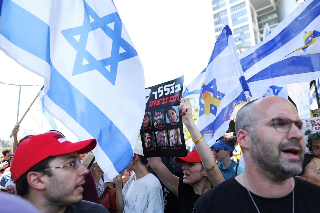 A demonstrator holds a sign as protesters rally outside Israel's defense ministry to show support for hostages who were kidnapped during the Hamas' Oct. 7 attack.