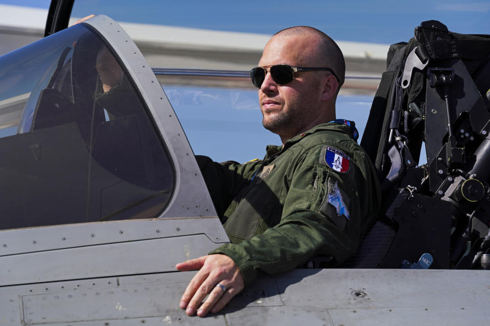 A French pilot watches as his Dassault Rafale fighter jet is pulled into position at the Dubai Air Show in Dubai, United Arab Emirates, Sunday, Nov. 14, 2021. The biennial Dubai Air Show opened Sunday as commercial aviation tries to shake off the coronavirus pandemic. (AP Photo/Jon Gambrell)