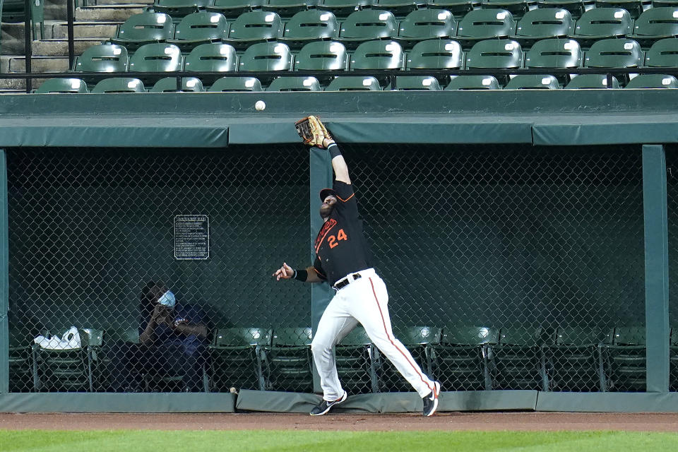 Baltimore Orioles right fielder DJ Stewart is unable to catch a triple off the wall by Tampa Bay Rays designated hitter Yoshitomo Tsutsugo during the third inning of a baseball game, Friday, Sept. 18, 2020, in Baltimore. (AP Photo/Julio Cortez)