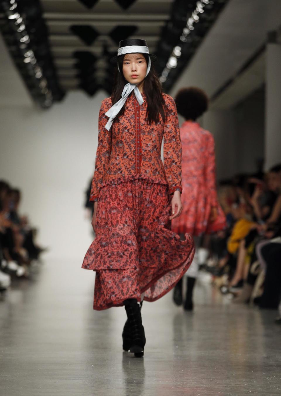 A model wears a creation by designer Bora Aksu during the runway show as part of London Fashion Week, Friday, Feb. 17, 2017. (AP Photo/Alastair Grant)