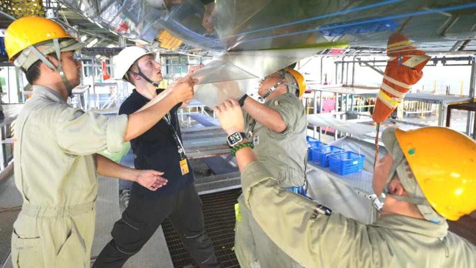 <em>Maintenance crews hired by EVA Air install an aerodynamic coating on a Boeing 777 freighter. (Photo: Lufthansa Technik)</em>