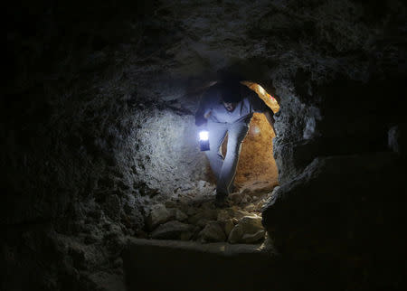 Hudhayfa al-Shahad walks in a makeshift shelter in an underground cave in Idlib, Syria September 3, 2018. Picture taken September 3, 2018. REUTERS/Khalil Ashawi