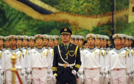 Members of the Chinese military honor guard stand in formation on May 9. China expressed Saturday its "firm opposition" to a Pentagon report that said Beijing was carrying out aggressive cyber espionage as part of a steady build-up of its military power, state media said